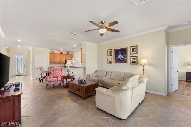 tiled living room with ceiling fan and ornamental molding