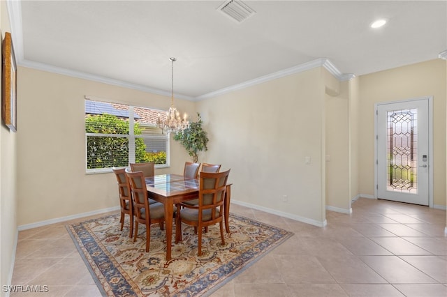 dining space with ornamental molding, an inviting chandelier, and light tile patterned floors