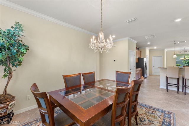 dining area featuring an inviting chandelier, crown molding, and light tile patterned floors