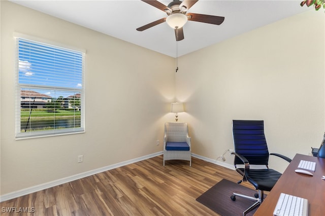 unfurnished office with wood-type flooring and ceiling fan