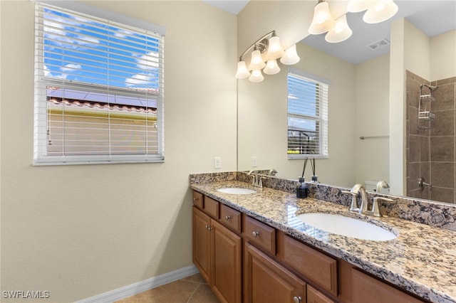 bathroom featuring tile patterned floors, vanity, and tiled shower