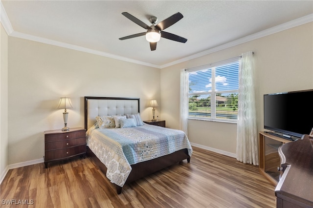 bedroom featuring ornamental molding, hardwood / wood-style floors, and ceiling fan