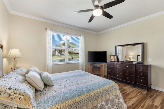 bedroom featuring crown molding, dark wood-type flooring, and ceiling fan