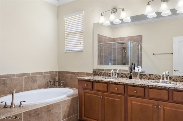 bathroom with plus walk in shower, ornamental molding, a notable chandelier, and vanity