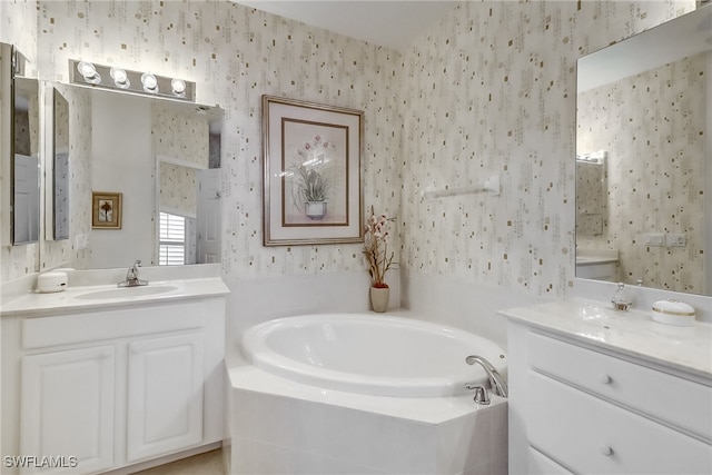 bathroom featuring tiled bath, vanity, and toilet