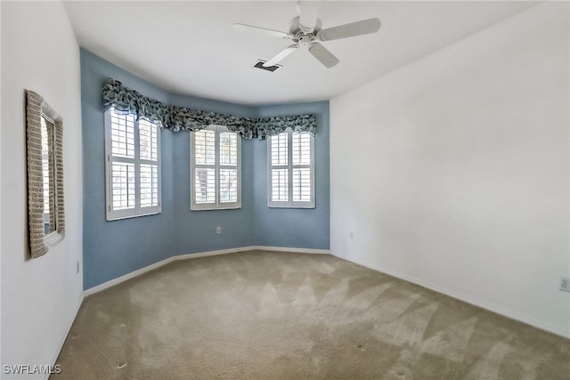 carpeted spare room with ceiling fan