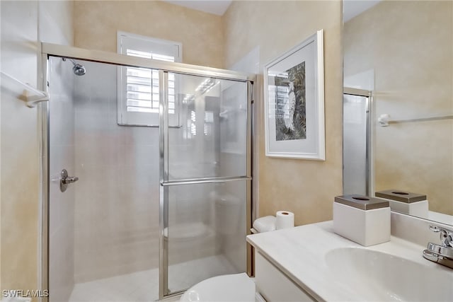 bathroom featuring vanity, toilet, and an enclosed shower