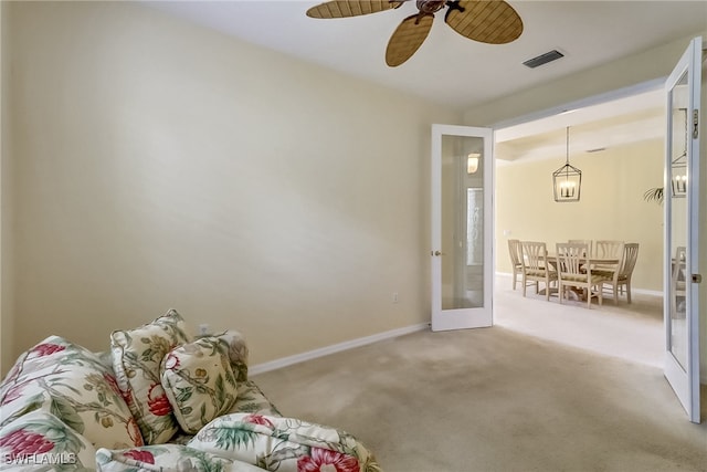 interior space with carpet, ceiling fan, and french doors