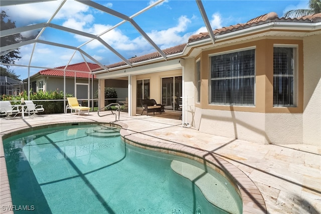 view of swimming pool featuring glass enclosure and a patio