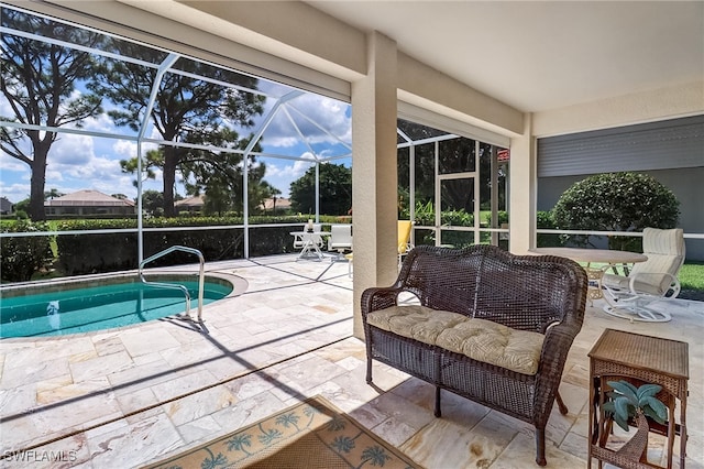 view of pool with a lanai and a patio