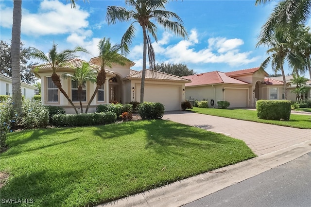 mediterranean / spanish-style home with a front lawn and a garage