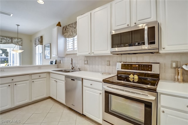 kitchen featuring white cabinetry, appliances with stainless steel finishes, and plenty of natural light