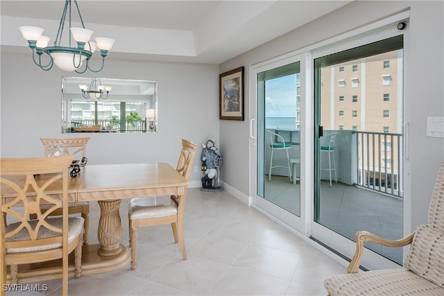 1036 S Collier Blvd Unit B-301, Marco Island, FL 34145 - dining area featuring a chandelier, baseboards, and light tile patterned floors