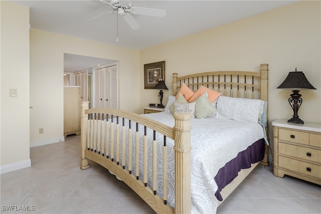 bedroom featuring ceiling fan, a closet, and light tile patterned floors