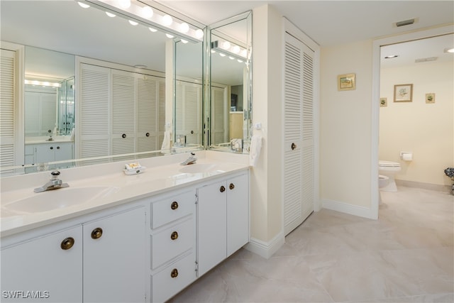 bathroom featuring a bidet, vanity, and toilet