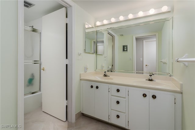 bathroom featuring shower / bath combination with glass door and vanity