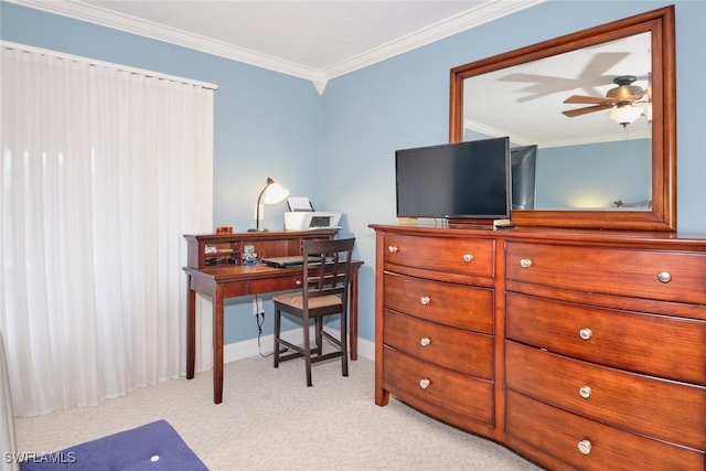 office space featuring ornamental molding, baseboards, ceiling fan, and light carpet