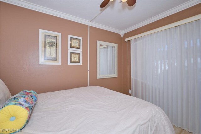 bedroom with ornamental molding and ceiling fan