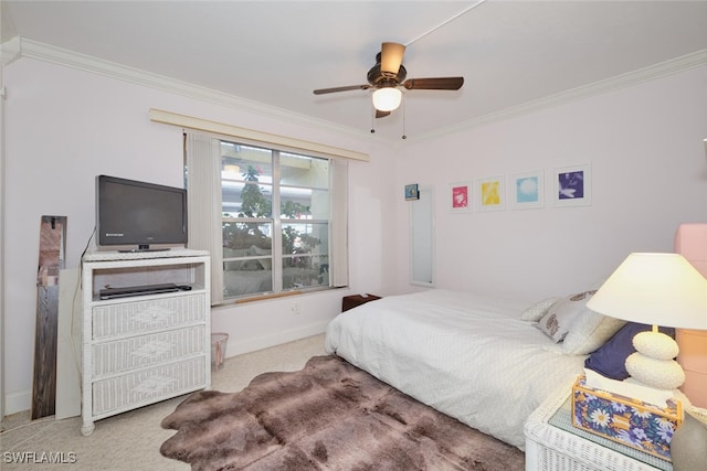 carpeted bedroom with baseboards, ornamental molding, and ceiling fan