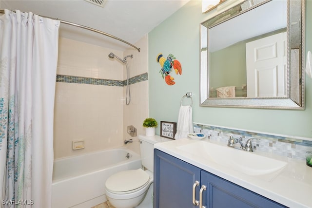 full bathroom with toilet, shower / bath combo with shower curtain, and vanity