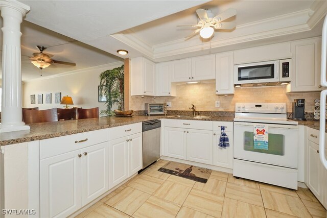kitchen featuring crown molding, white appliances, decorative columns, a sink, and a ceiling fan