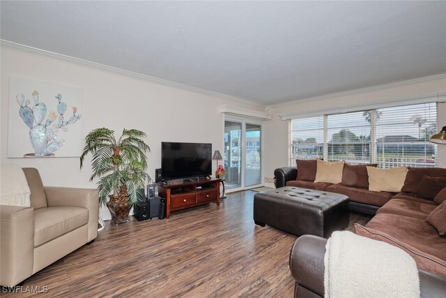 living room with dark hardwood / wood-style floors and crown molding