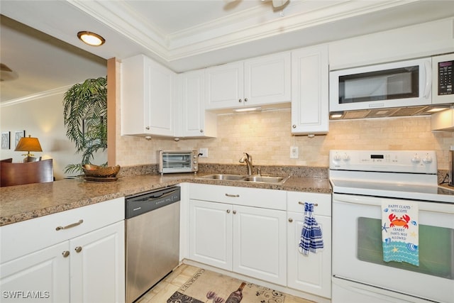 kitchen featuring a sink, tasteful backsplash, crown molding, and white appliances