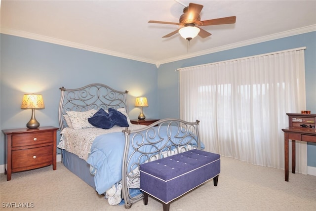 carpeted bedroom featuring crown molding and a ceiling fan