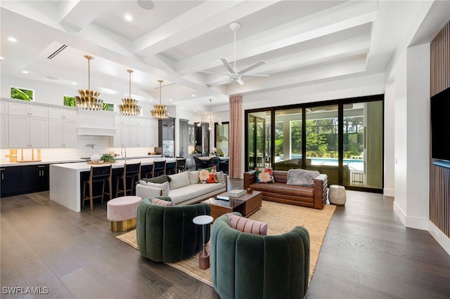 living room featuring ceiling fan, beamed ceiling, and dark wood-type flooring