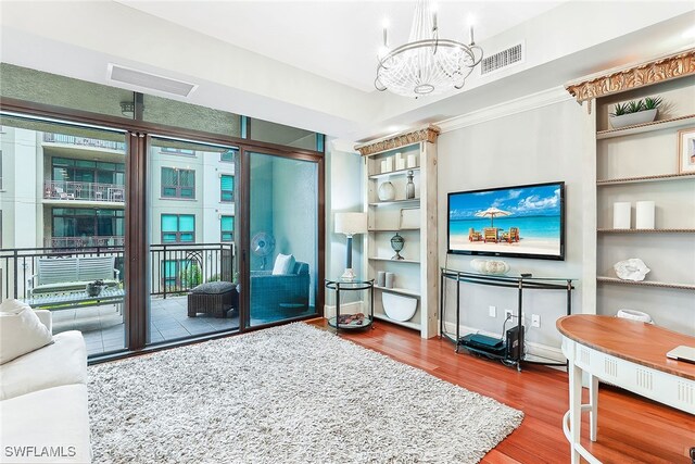 living room featuring hardwood / wood-style flooring and a notable chandelier