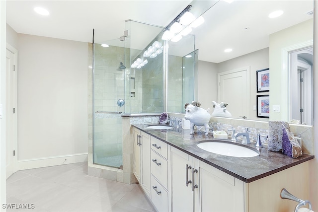 bathroom featuring vanity, a shower with shower door, and tile patterned floors