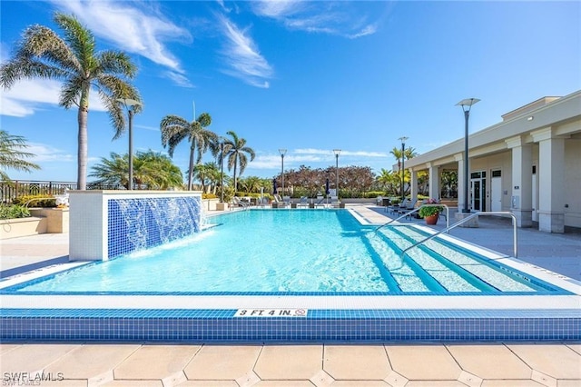 view of pool featuring pool water feature and a patio area