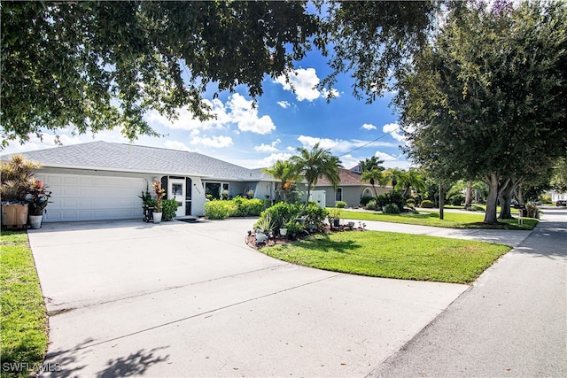 single story home featuring a garage and a front lawn