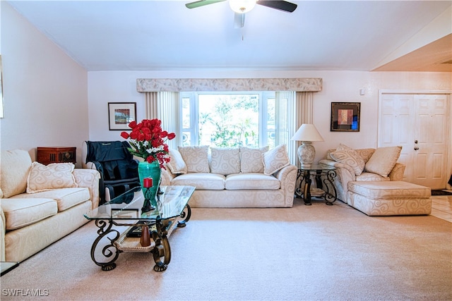 carpeted living room featuring ceiling fan and vaulted ceiling