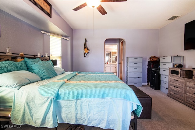 carpeted bedroom with connected bathroom and ceiling fan