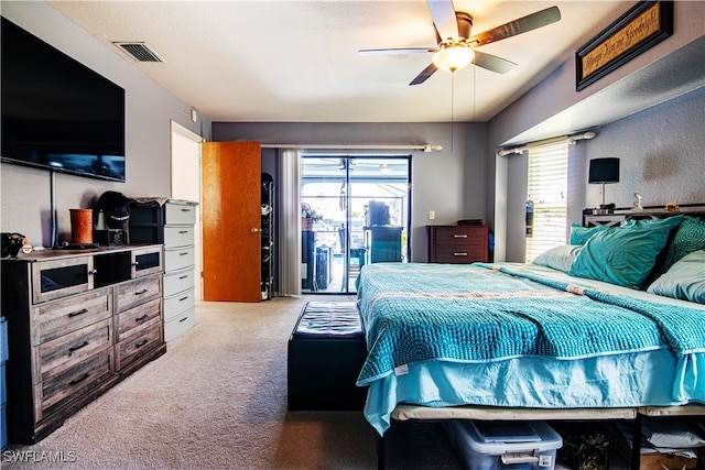 bedroom featuring light carpet, multiple windows, access to exterior, and ceiling fan