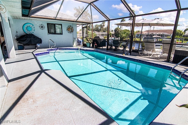 view of pool featuring a patio, a lanai, and a grill