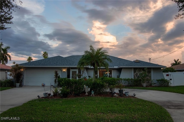 single story home with a lawn and a garage