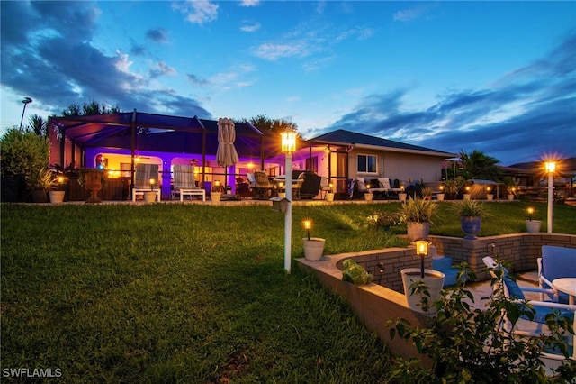 yard at dusk featuring a patio and a lanai