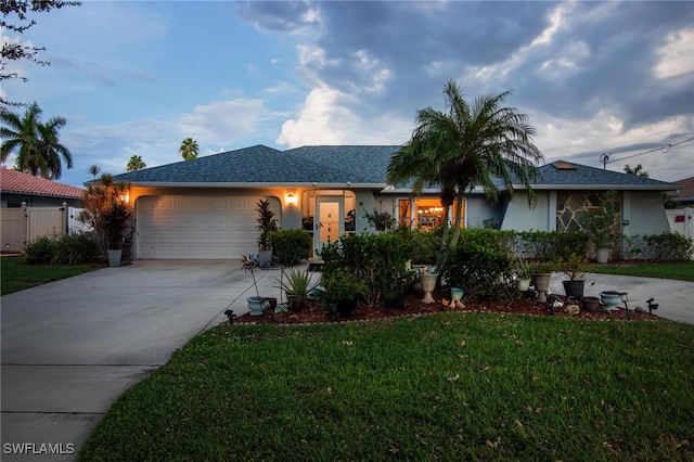 single story home with a front yard and a garage