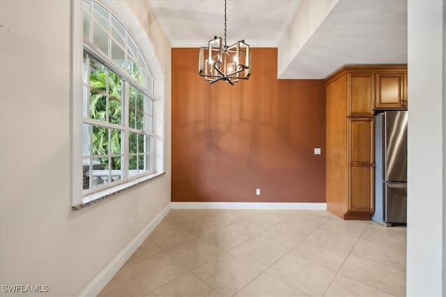 unfurnished dining area featuring crown molding, an inviting chandelier, and light tile patterned floors