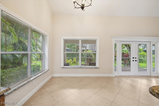 interior space featuring french doors, a notable chandelier, and a wealth of natural light