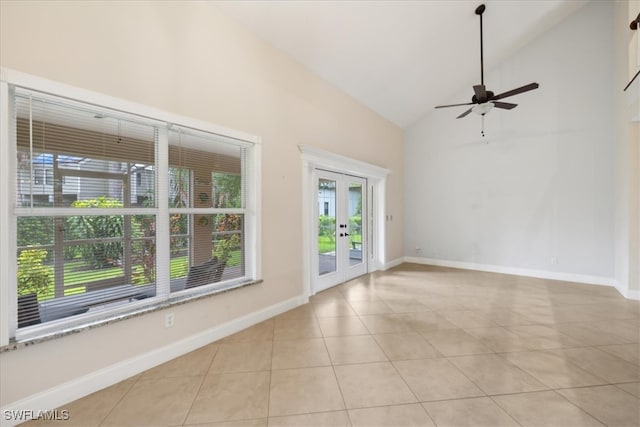 empty room with french doors, ceiling fan, high vaulted ceiling, and light tile patterned floors