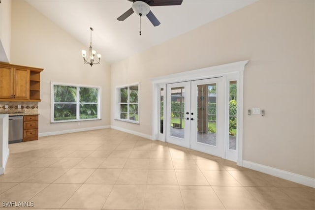 unfurnished living room featuring light tile patterned flooring, french doors, a healthy amount of sunlight, and high vaulted ceiling