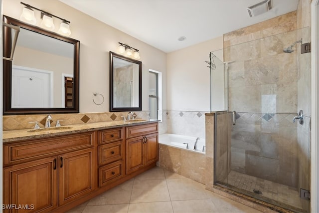 bathroom featuring vanity, independent shower and bath, and tile patterned flooring