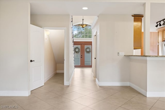 foyer featuring french doors and light tile patterned floors