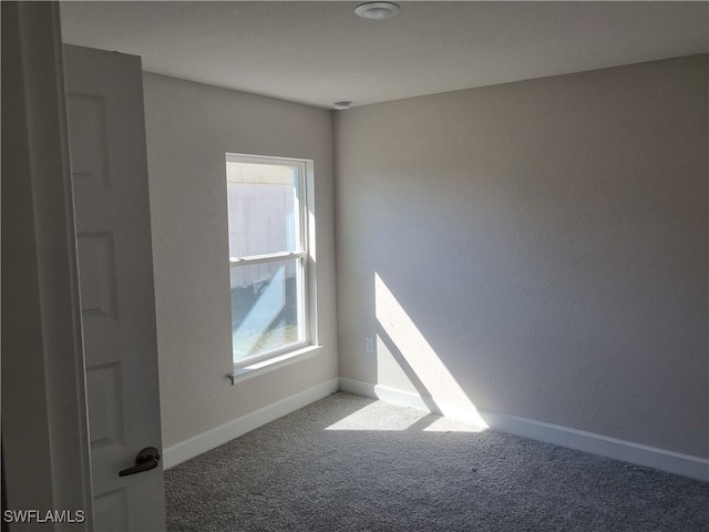 carpeted empty room featuring plenty of natural light