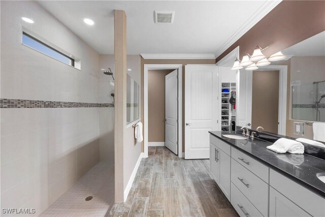 12917 Hadley Ct, Fort Myers, FL 33913 - bathroom with walk in shower, double vanity, wood finished floors, ornamental molding, and a spacious closet