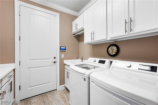 12917 Hadley Ct, Fort Myers, FL 33913 - laundry room featuring washing machine and dryer, crown molding, cabinet space, and light wood-style floors