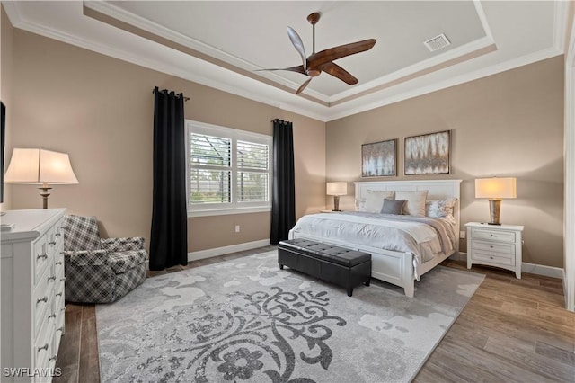 12917 Hadley Ct, Fort Myers, FL 33913 - bedroom featuring a raised ceiling, crown molding, wood finished floors, and baseboards